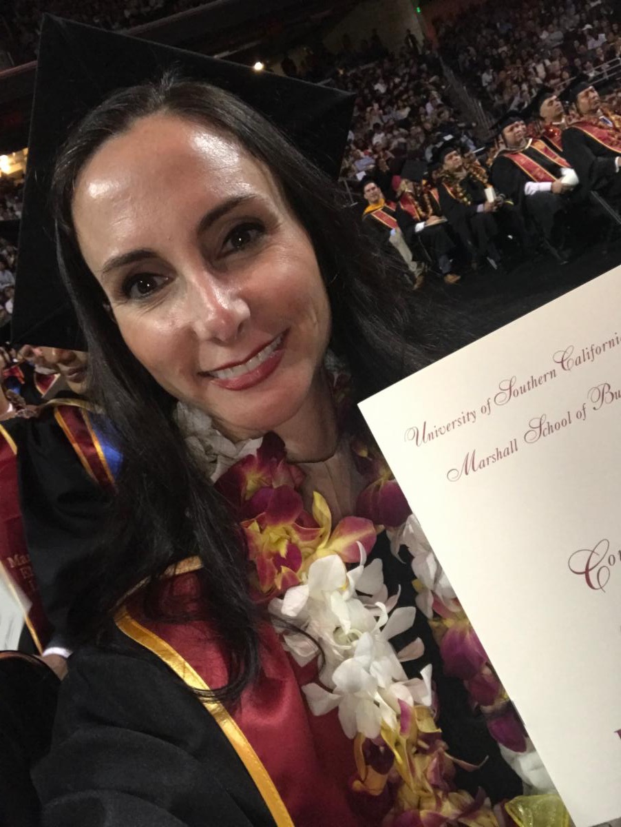 CEO Michelle Constant with her diploma for earning an MBA from the University of Southern California.