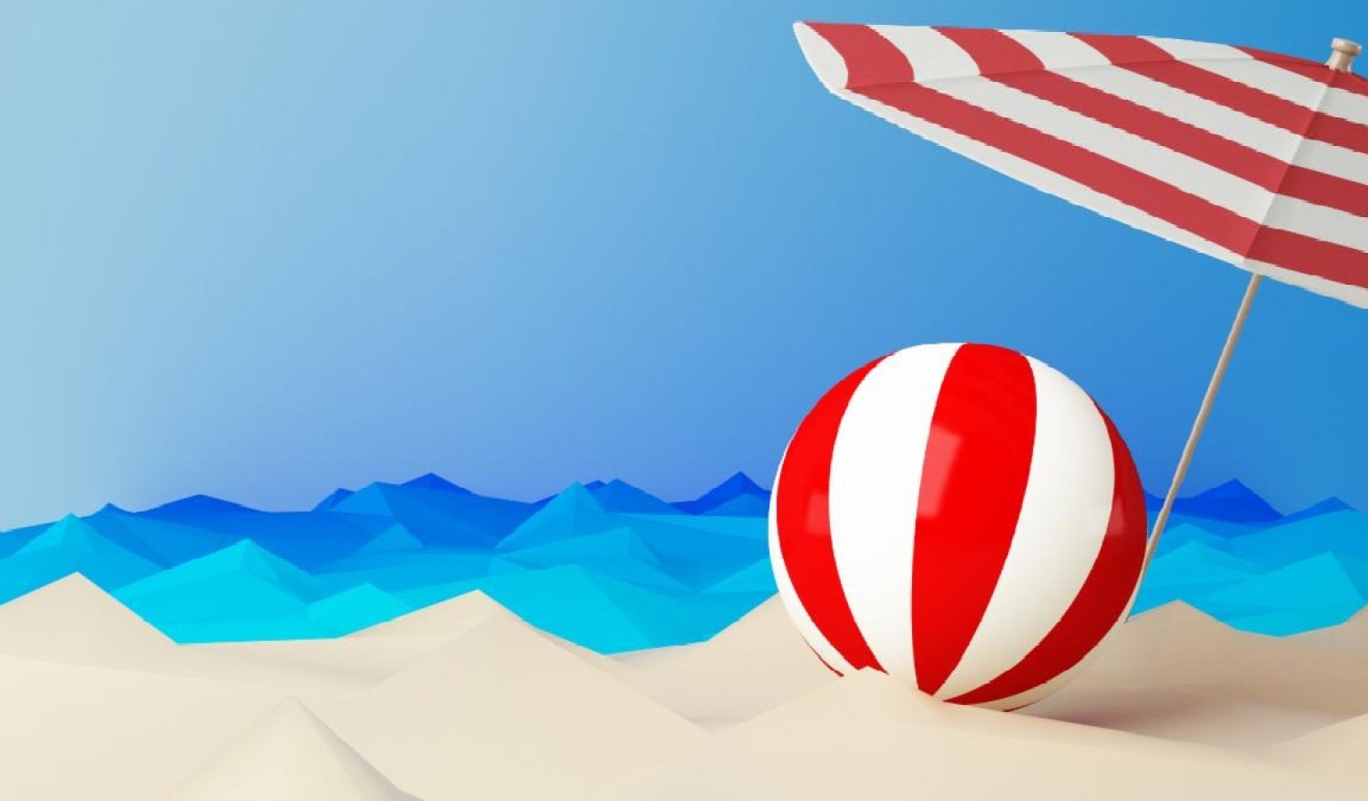 Photo of american flag-decorated beach umbrella and beach ball on a sandy beach.